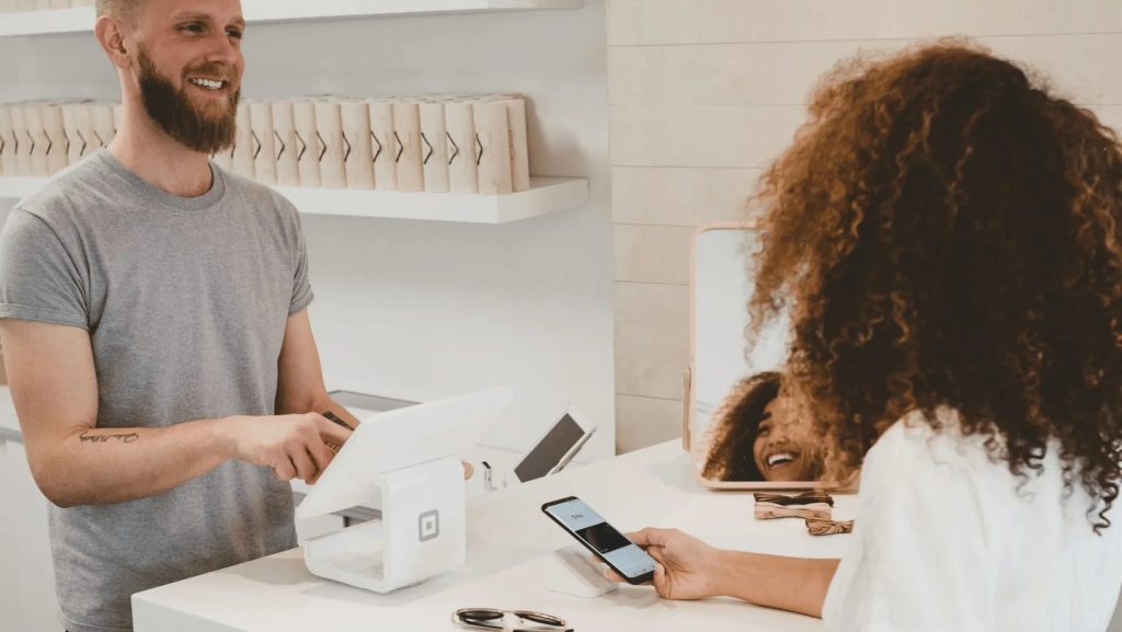 Coffee shop customer paying using square POS